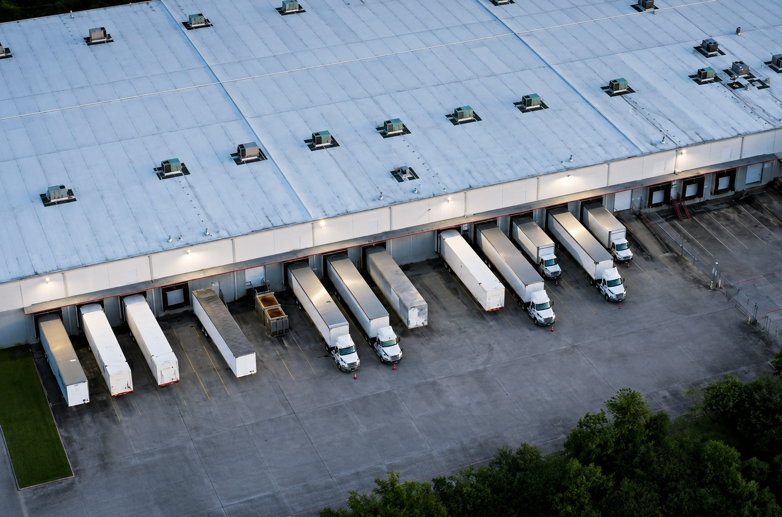 Logistics facility with trucks at warehouse loading bays
